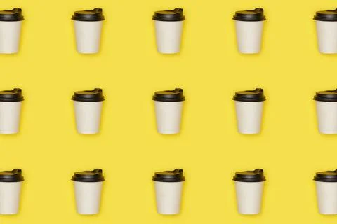 Flat lay paper white cup with back plastic cover pattern on yellow illuminating Stock Photos