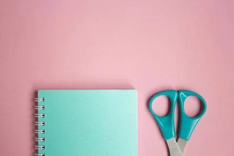 Flat lay pastel composition. background with mint colored notepad and scissor Stock Photos