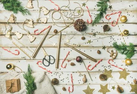Flat-lay pattern of holiday decoration objects, toys, candles, candy canes Stock Photos