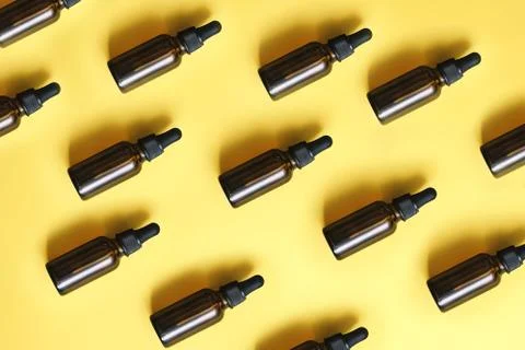 Flat lay pattern of natural cosmetics from small glass oil bottles. Jars with Stock Photos