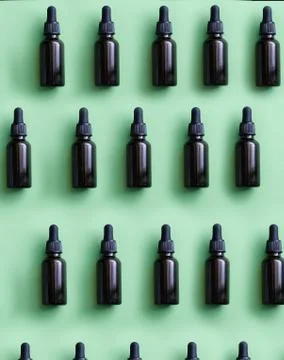 Flat lay pattern of natural cosmetics from small glass oil bottles Stock Photos