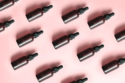 Flat lay pattern of natural cosmetics from small glass oil bottles. Jars with Stock Photos