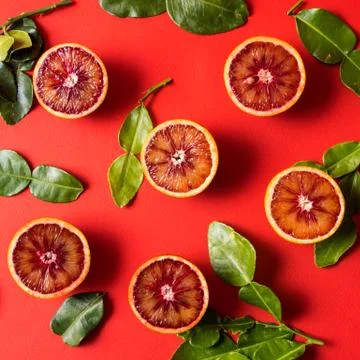 Flat lay the pattern with raw fresh red orange citrus fruit with green leaves Stock Photos