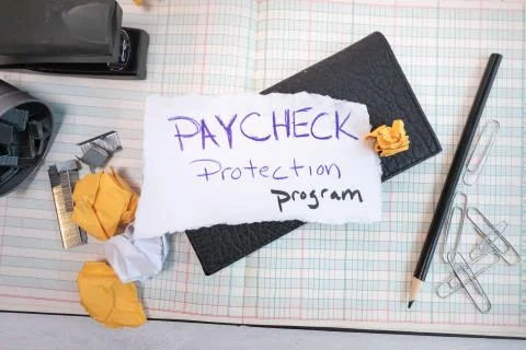 Flat lay Paycheck protection program note with financial bookkeeping ledger Stock Photos