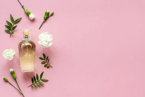 Flat lay of perfume bottle with flowers, top view Stock Photos