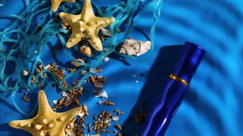 Flat lay perfume bottle of water background with starfish, sea or ocean shells Stock Footage 196279869