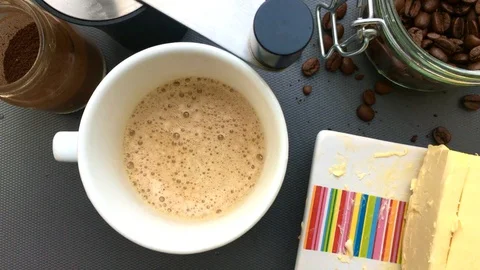 Flat lay person making bulletproof coffee in kitchen at home- 8s Stock Footage 128931885