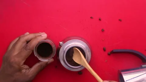 Flat lay person preparing espresso coffee with a moka pot at home - 8s Stock Footage 130617968