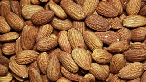 Flat lay pile of peeled raw almond nut seed food background footage rotate Stock Footage 262306314