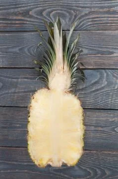 Flat lay of pineapple cut in half. White wooden table. Top view, overhead. Stock Photos