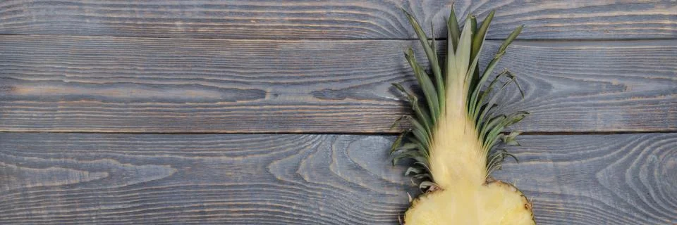 Flat lay of pineapple cut in half. White wooden table. Top view, overhead. Stock Photos
