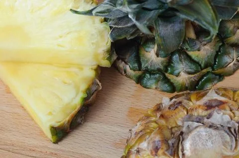 Flat lay of pineapple cut in slice. wooden table. Top view, overhead. Stock Photos