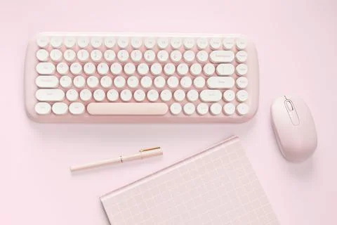 Flat lay pink color computer and stationery Stock Photos
