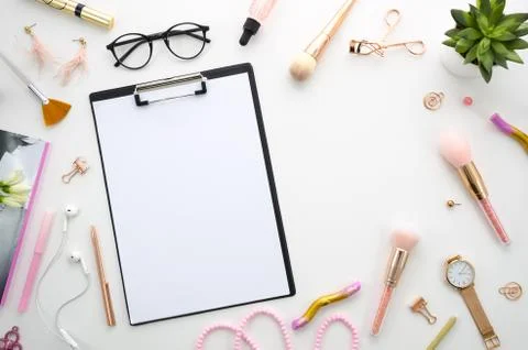 Flat lay pink composition with blank clipboard, cosmetics, makeup tools, on Stock Photos
