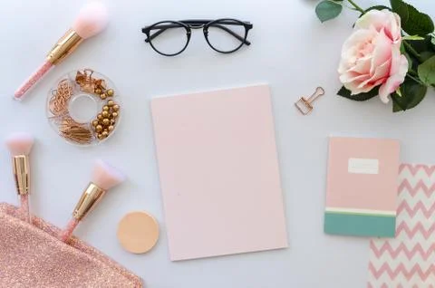 Flat lay pink composition with blank note cosmetics, makeup tools, glasses and Stock Photos