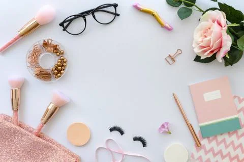 Flat lay pink composition with copy space, blank note, cosmetics, makeup tools Stock Photos
