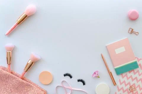 Flat lay pink composition with cosmetics, makeup tools and accessory on white Stock Photos
