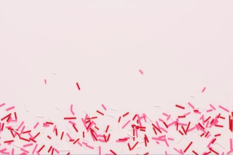 Flat lay of pink sprinkles over background, festive decoration for banner, .. Stock Photos