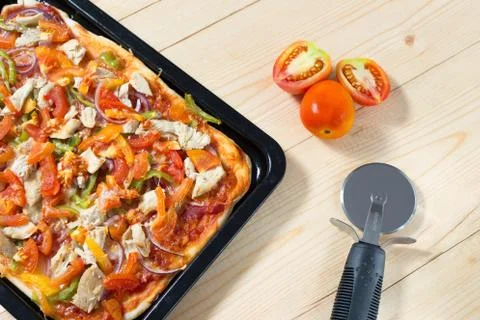 Flat lay pizza composition, tomatoes on wooden surface, close up macro Stock Photos