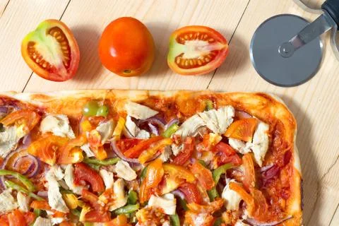 Flat lay pizza composition, tomatoes on wooden surface, close up macro Stock Photos