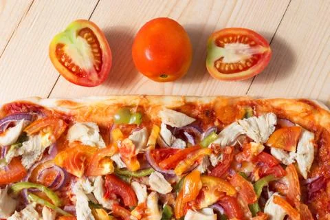 Flat lay pizza composition, tomatoes on wooden surface, close up macro Stock Photos
