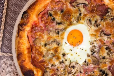 Flat lay pizza with egg ham mushrooms Stock Photos
