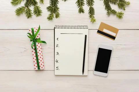 Flat lay of planner pen gift card phone on white table Stock Photos