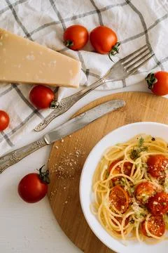 Flat lay portion of spaghetti pasta with cherry tomatoes sprinkled with spices Stock Photos