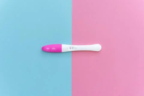 Flat lay of pregnancy test kit with two stripes. Stock Photos