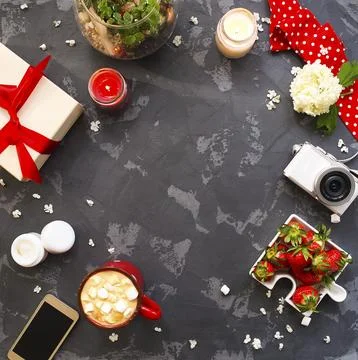 Flat lay with present, candles, cofffee and red ribbon. Top view Stock Photos