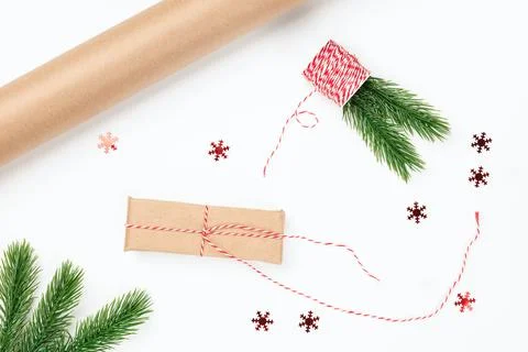 Flat lay process of wrapping Christmas gifts with craft paper, red rope Stock Photos