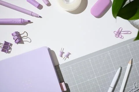 Flat lay of purple notebook, markers, pen, pencils, eraser, tape on white b.. Stock Photos