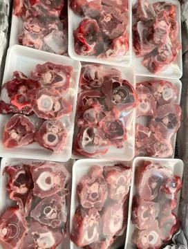 Flat Lay of Raw Beef Oxtail Cuts Packaged in Styrofoam Trays Stock Photos