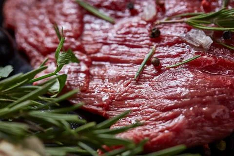 Flat lay of raw beefsteak with vegetables, herbs and spicies on metal tray Stock Photos