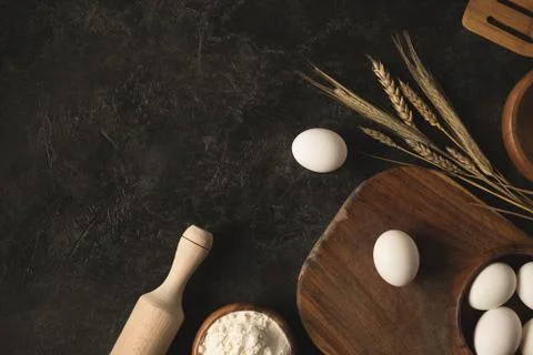 Flat lay with raw eggs, flour and various kitchen utensils for bakery isolate Stock Photos