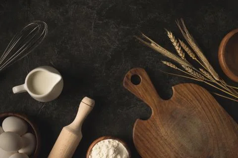 Flat lay with raw eggs, flour and various kitchen utensils for bakery isolate Stock Photos
