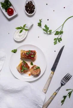 Flat lay with ready to eat cabbage rolls and ingredients on white background Stock Photos