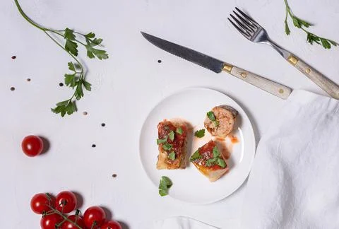 Flat lay with ready to eat cabbage rolls on white background Stock Photos