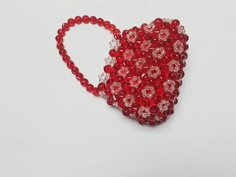 Flat lay red beaded retro purse on white background Stock Photos