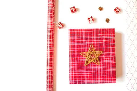 Flat lay with red gift box and wrapping paper, isolated on white background. Stock Photos