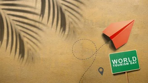 Flat lay of a red paper airplane, a green World Tourism Day sign, and palm .. Stock Photos