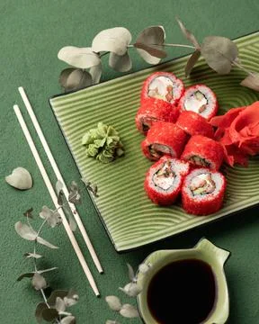 Flat lay. Red Sushi roll in masago or tobiko caviar. Inside-out Sushi Set on Stock Photos