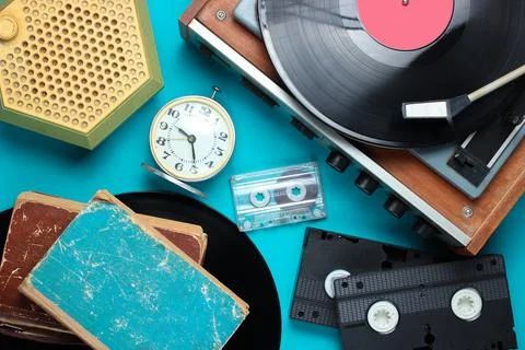 Flat lay retro style attributes, 80s media. Vinyl player, video cassettes, au Stock Photos