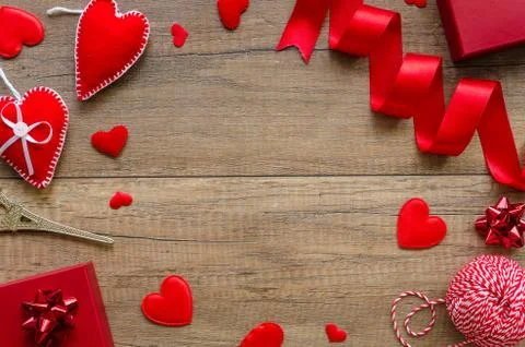 Flat lay romantic card concept. Border arrangement with hearts, red ring box on Stock Photos