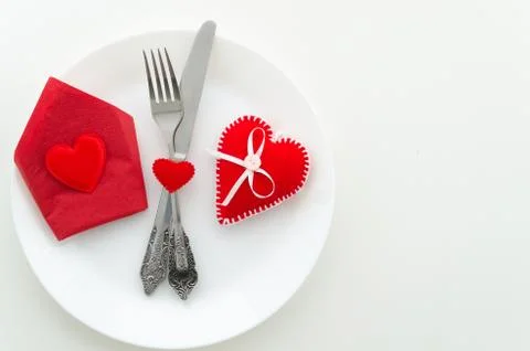 Flat lay romantic dinner proposal concept. Dish with cutlery and heard shape box Stock Photos