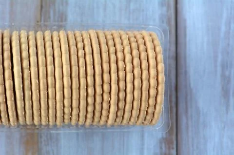 Flat lay of round biscuits in plastic container Stock Photos