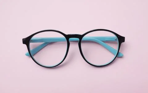 Flat lay round black Eye Glasses isolate on a pink pastel Background Stock Photos
