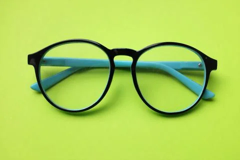 Flat lay round black Eye Glasses isolate on a green Background Stock Photos
