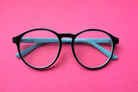 Flat lay round black Eye Glasses isolate on a pink Background Stock Photos