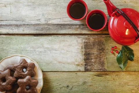 Flat lay of rustic wooden table with star chocolate cookies in ceramic plate Stock Photos